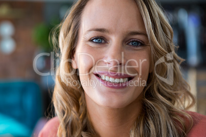 Close-up of woman smiling in cafeteria