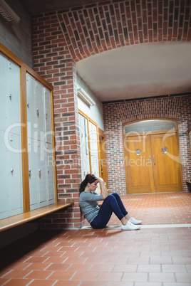 Stressed mature student sitting in locker room