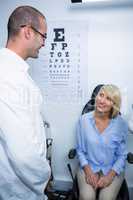 Optometrist interacting with female patient