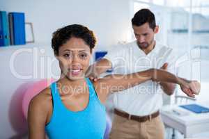 Physiotherapist examining womans shoulder