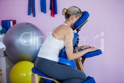 Woman sitting on massage chair