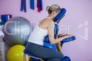 Woman sitting on massage chair