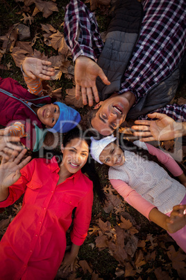 Happy family gesturing while forming huddle