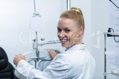 Female optometrist adjusting phoropter