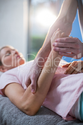 Physiotherapist massaging hand of a female patient