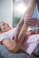 Physiotherapist massaging hand of a female patient