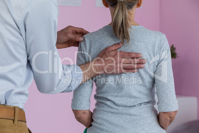 Physiotherapist giving neck massage to female patient