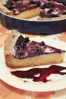 Piece of pie with bilberry on the plate