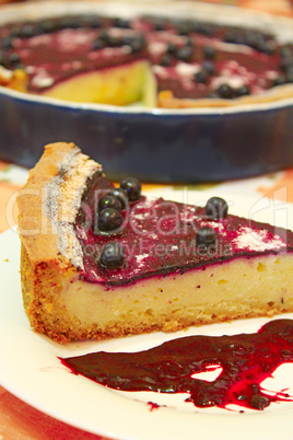 Piece of pie with bilberry on the plate