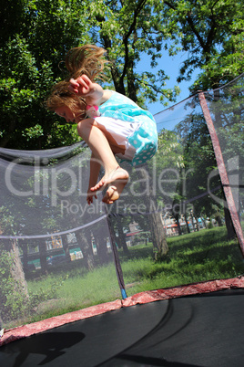 girl jumps on the trampoline