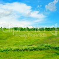 hills, green grass and blue cloudy sky