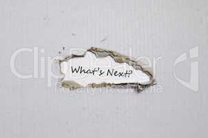 The words what's next appearing behind torn paper