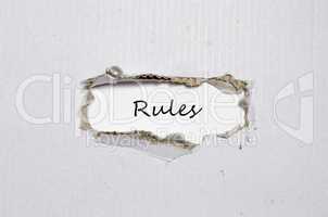 The word rules appearing behind torn paper