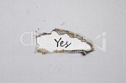 The word yes appearing behind torn paper