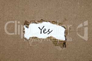 The word yes appearing behind torn paper