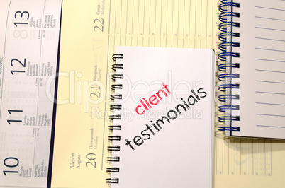 Client testimonials text concept on notebook