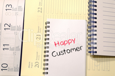 Happy customer text concept on notebook