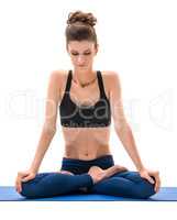 Yoga. Cute brunette sitting in lotus position