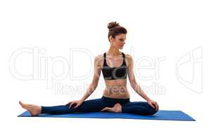 Pretty brunette engaged in yoga. Isolated on white