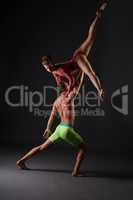 Duet of acrobats perform trick in studio