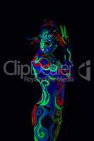Girl with body art glowing in ultraviolet light