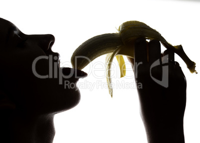 Close-up of Young amazed woman holding a banana, she is going to eat a banana. she sucks a banana