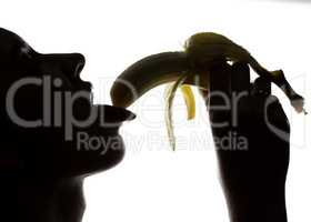 Close-up of Young amazed woman holding a banana, she is going to eat a banana. she sucks a banana