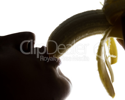 Close-up of Young amazed woman holding a banana, she is going to eat a banana. she sucks a banana