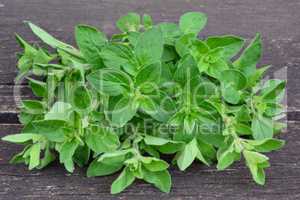 Oregano leaves on old oak table