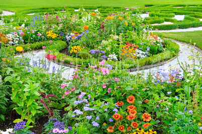 summer flower bed and green lawn