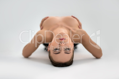 Close-up face of topless young woman doing yoga
