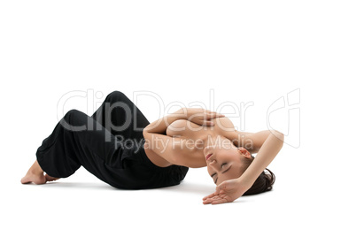 Yoga. Relaxed young woman posing topless in studio