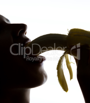 Close-up of Young amazed woman holding banana, she is going to eat a banana. she sucks a banana