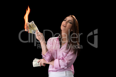 Concept of financial crisis. Woman burns money