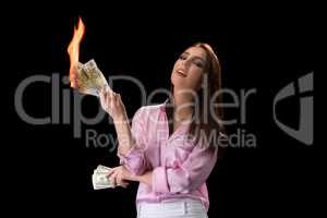 Concept of financial crisis. Woman burns money