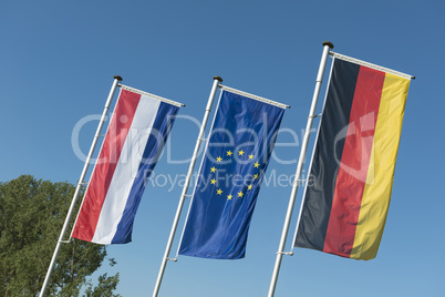 Dutch flag, European Union flag and German flag.