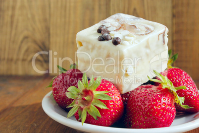 strawberries and sweet cake on the white plate