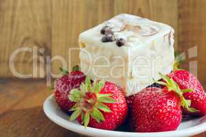 strawberries and sweet cake on the white plate