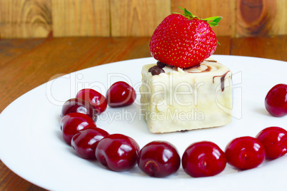 strawberries and cherries on the plate and cake