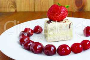 strawberries and cherries on the plate and cake