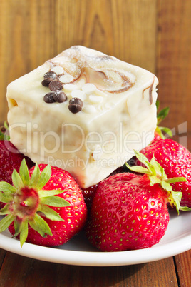 strawberries and sweet cake on the white plate