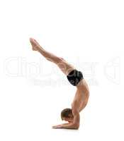 Sport. Athlete doing handstand, isolated on white