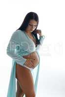 Attractive expectant mother touching her belly