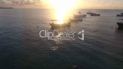 Flying Drone Shot Of Sunset Over The Sea Passing A Fisherman On His Boat