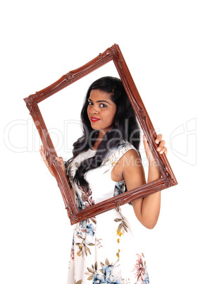 Woman looking trough frame.