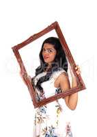 Woman looking trough frame.