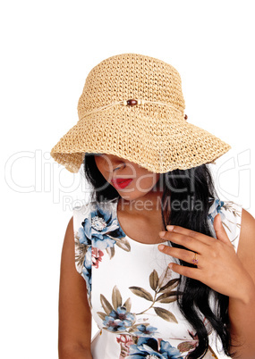 Woman with straw hat looking down.