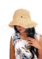 Woman with straw hat looking down.