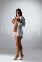 Full length photo of pregnant woman poses topless