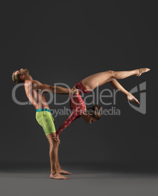 Acrobatic duo posing while practicing in studio